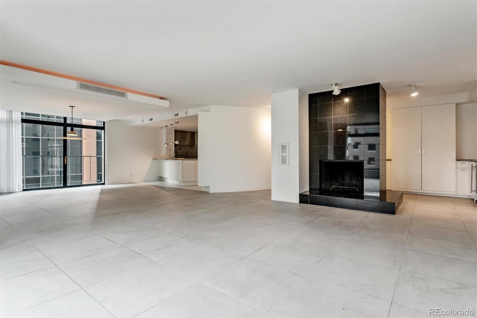 1777 Larimer Street, Unit 710 Denver, CO 80202 - Photo 20 of 33 a view of an empty room with kitchen and a window