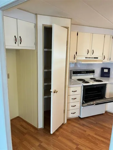 a kitchen with a cabinets and wooden floor