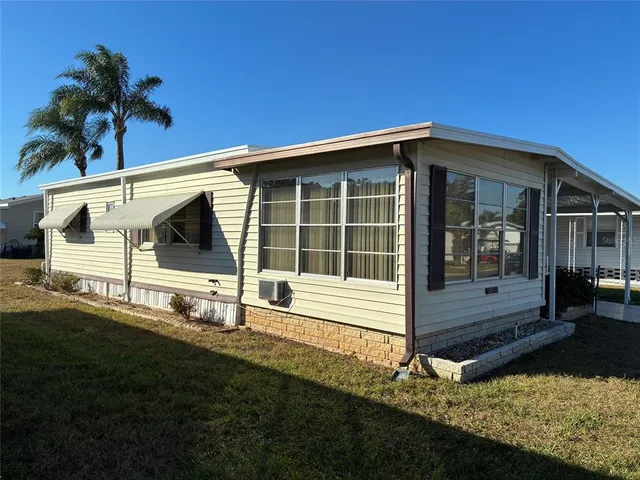 a view of house with backyard and garden