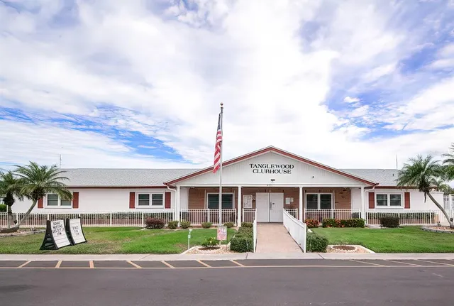 a front view of a house with garden and lake view