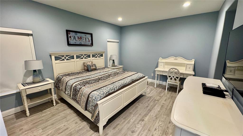 6826 Sorrento Street Orlando, FL 32819 - Photo 11 of 28 a bedroom with a bed and a flat screen tv