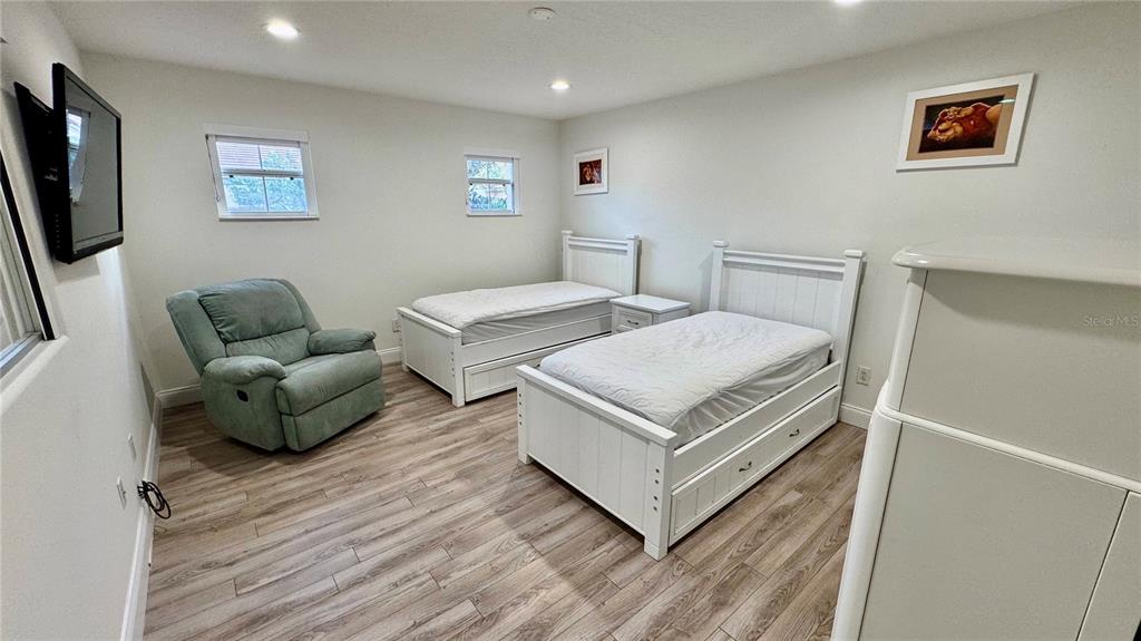 6826 Sorrento Street Orlando, FL 32819 - Photo 20 of 28 a bedroom with a bed and a couch