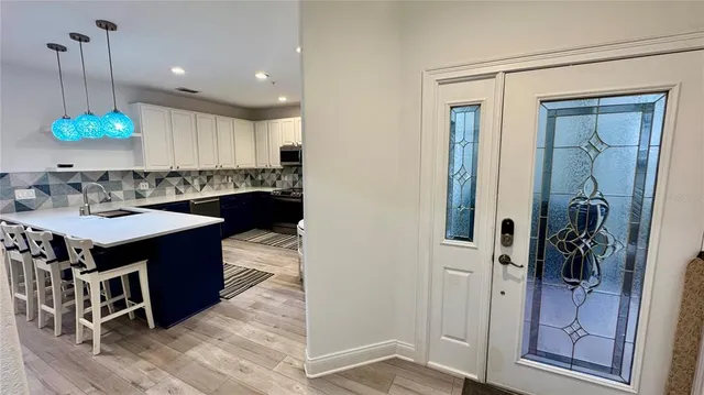 a kitchen with a refrigerator and a sink