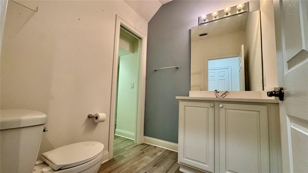 6826 Sorrento Street Orlando, FL 32819 - Photo 21 of 28 a bathroom with a granite countertop toilet sink and mirror