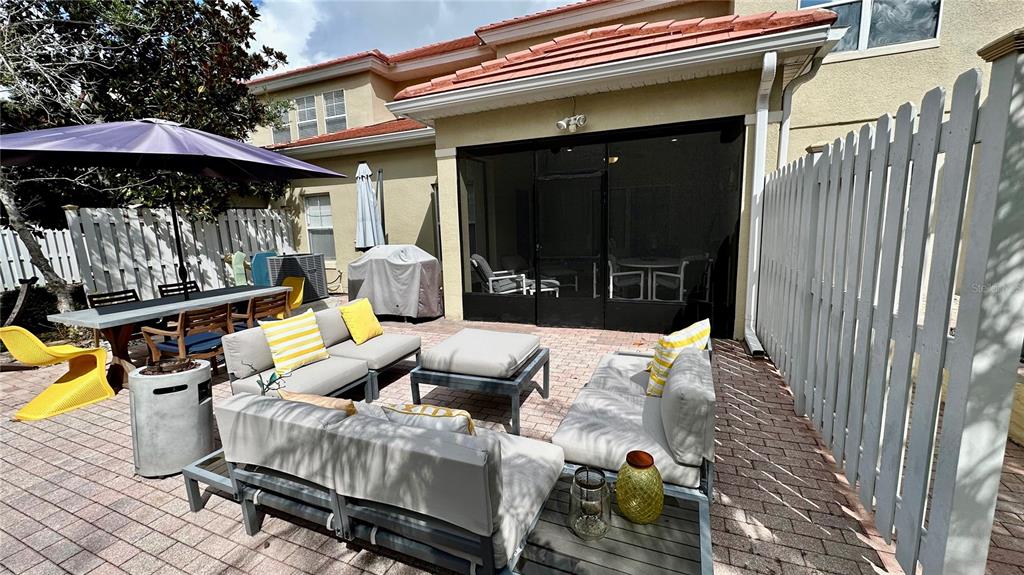6826 Sorrento Street Orlando, FL 32819 - Photo 24 of 28 a view of a patio with furniture and floor to ceiling window