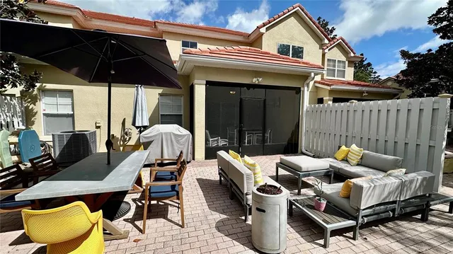 a view of a patio with table and chairs under an umbrella