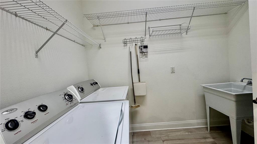 6826 Sorrento Street Orlando, FL 32819 - Photo 27 of 28 a utility room with dryer and washer