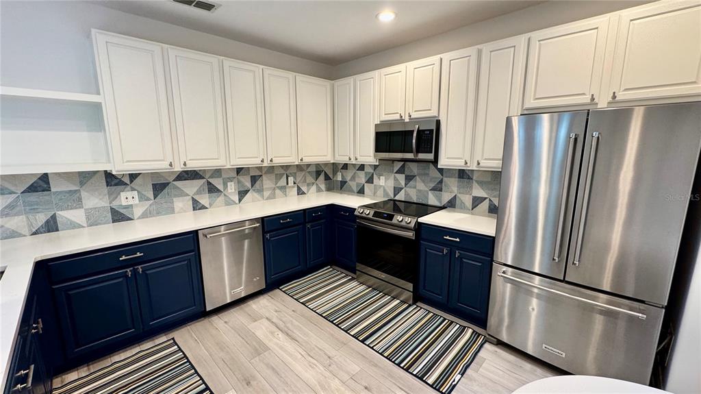 6826 Sorrento Street Orlando, FL 32819 - Photo 6 of 28 a kitchen with a refrigerator sink and cabinets