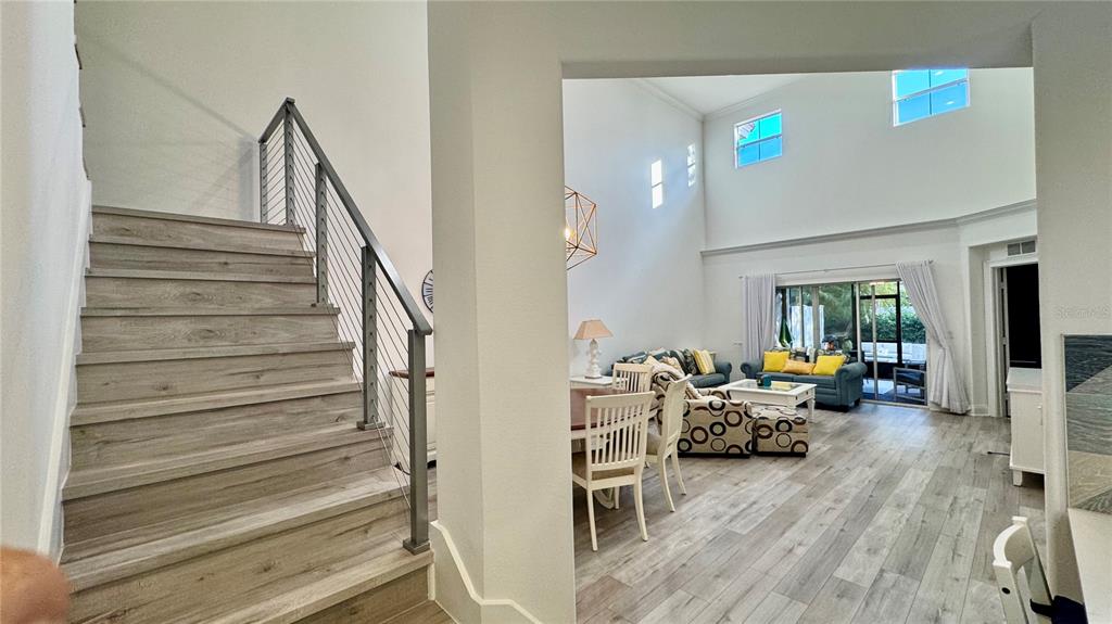 6826 Sorrento Street Orlando, FL 32819 - Photo 8 of 28 a living room with furniture and a chandelier