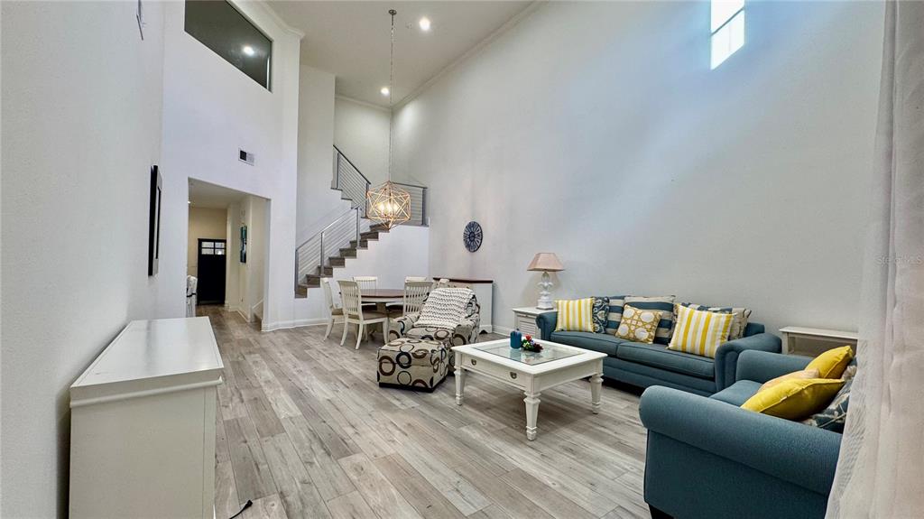 6826 Sorrento Street Orlando, FL 32819 - Photo 10 of 28 a living room with furniture and wooden floor