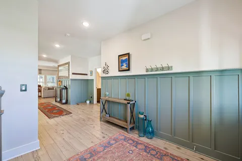 a view of a livingroom with furniture a fireplace and wooden floor