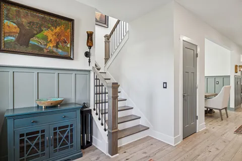 a view of a livingroom with furniture a fireplace and wooden floor
