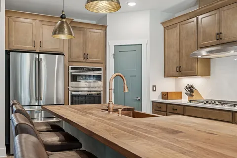 a bedroom with a bed a mirror and a window