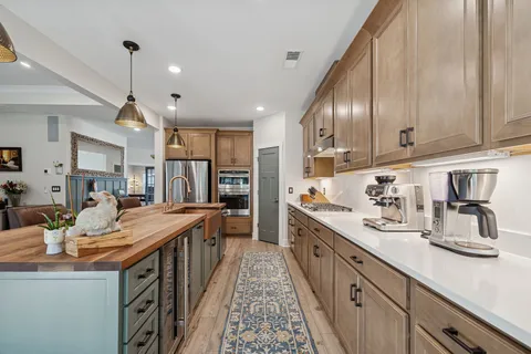a bathroom with a tub a sink double vanity and a mirror