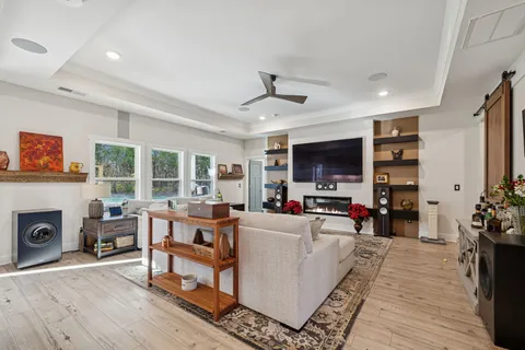 a living room with furniture and wooden floor