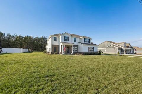 a view of a house with a backyard