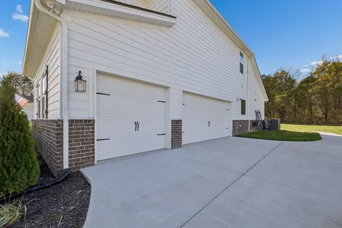 a living room with furniture pool table and hallway