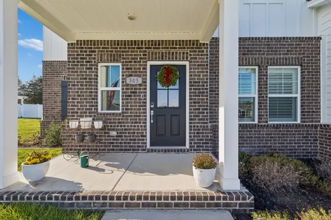 a large kitchen with stainless steel appliances granite countertop a stove a sink a dining table and chairs with wooden floor