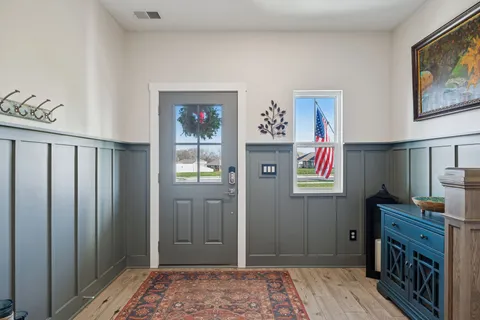 a large kitchen with stainless steel appliances granite countertop a stove a sink a dining table and chairs with wooden floor