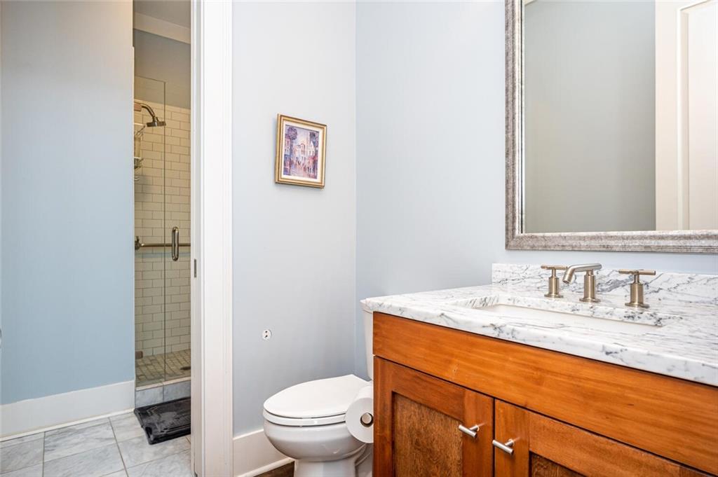 123 Ansley Street Decatur, GA 30030 - Photo 33 of 61 a bathroom with a granite countertop sink mirror vanity and toilet