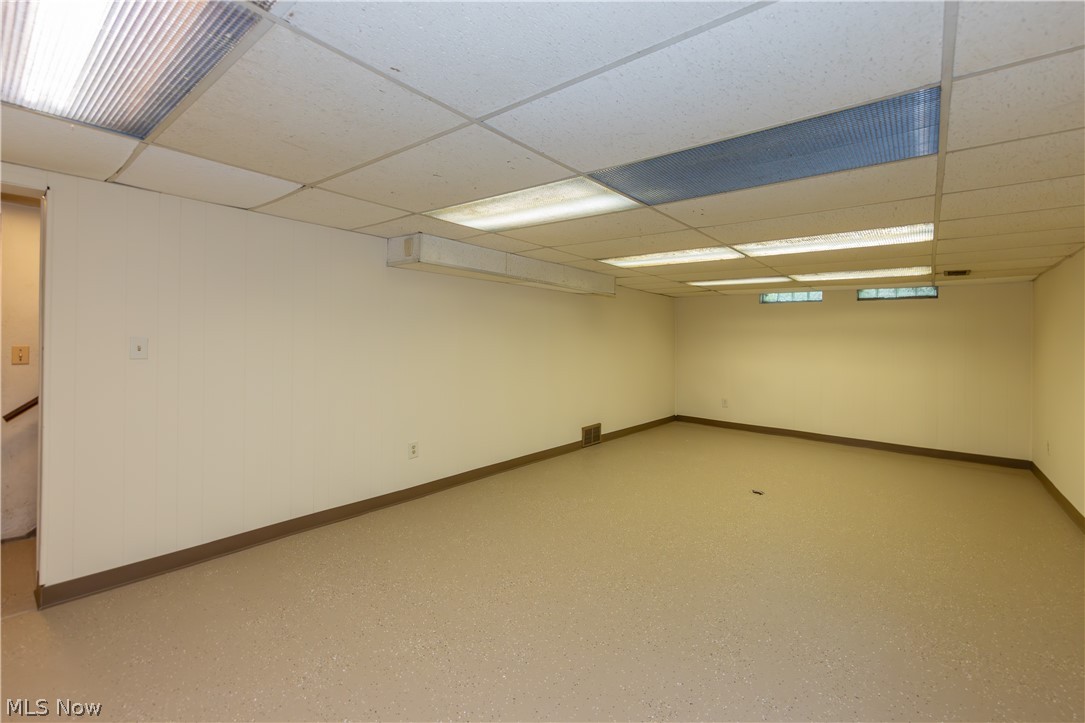 25001 Letchworth Road Beachwood, OH 44122 - Photo 40 of 50 Expansive room with neutral walls, light-toned flooring, and a drop ceiling with integrated fluorescent lighting