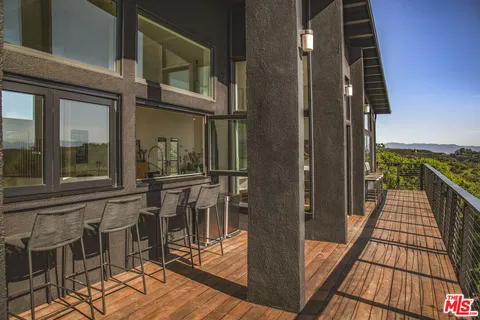 a view of balcony with furniture