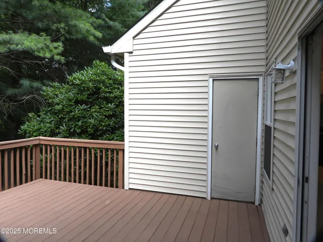 a balcony view with a wooden floor and a potted plant