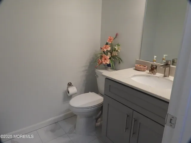a bathroom with a sink toilet and mirror