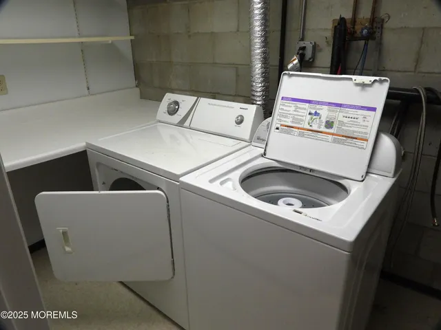 a view of an empty room with wooden floor and stairs