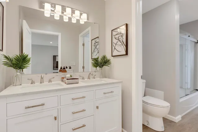 a bathroom with a toilet a sink and mirror