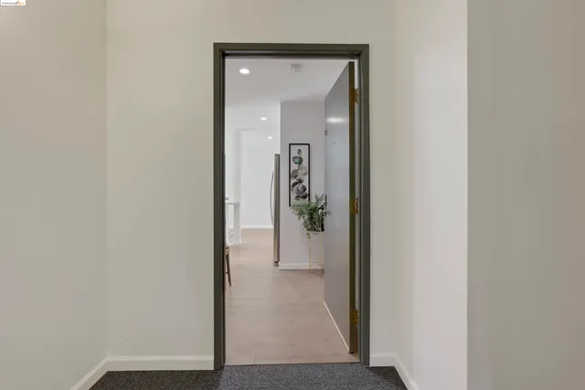 a view of a hallway with wooden floor