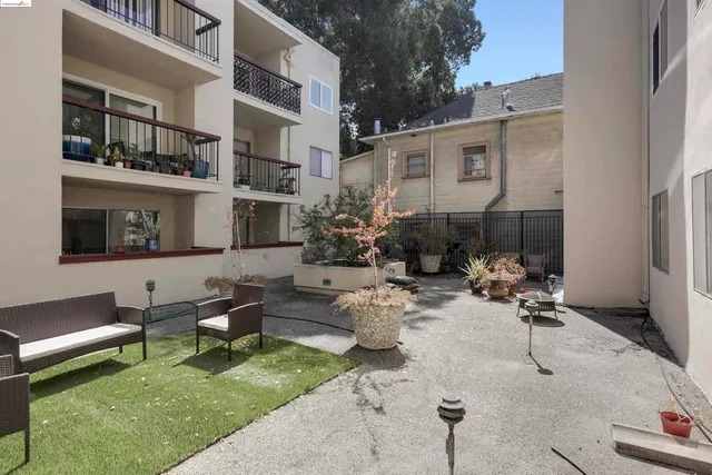 a view of a patio with dining table and chairs with plants