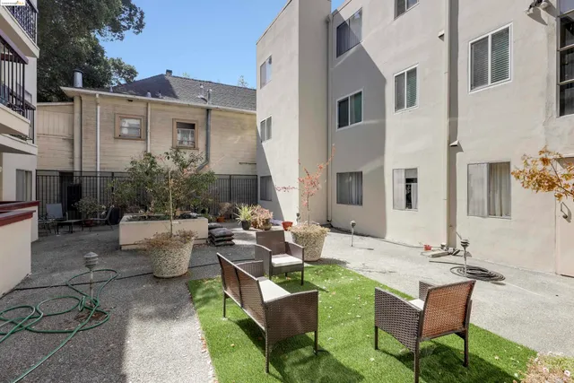 a view of a patio with couches table and chairs and potted plants