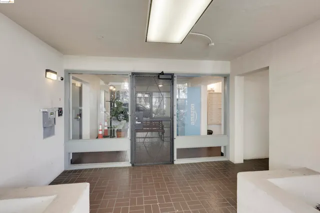 a view of an empty room and a bathroom