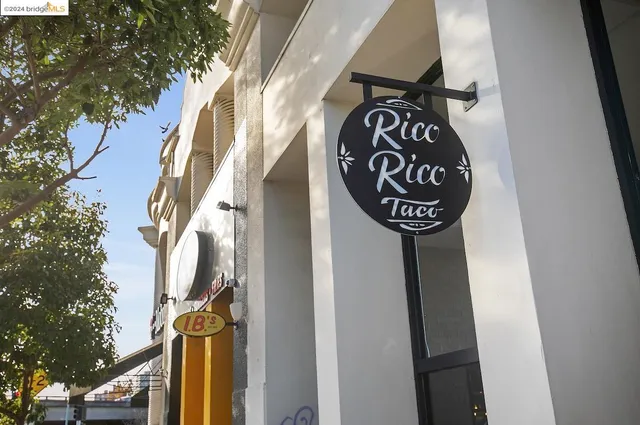 a view of a city street lined with buildings and trees