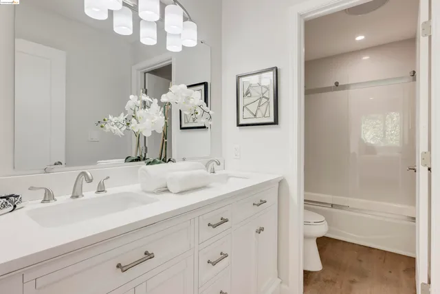 a bathroom with a sink a mirror and a shower