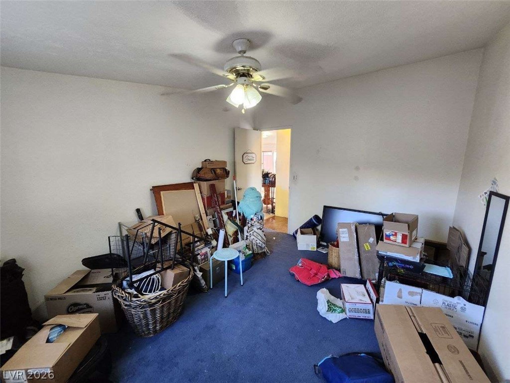942 Holt Caliente, NV 89008 - Photo 16 of 22 A versatile room awaits transformation, featuring a ceiling fan and plush carpeting.