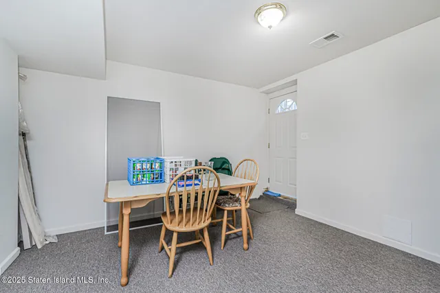 a dining room with a table and chairs