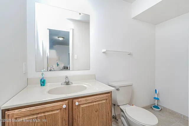 a bathroom with a sink toilet and mirror