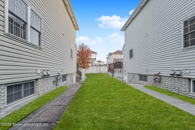 a view of a house with a yard and sitting area