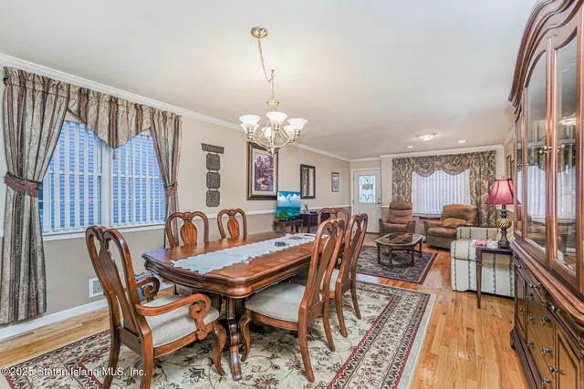 a dining room with furniture window and wooden floor