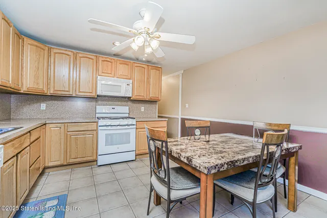 a kitchen with a stove a sink cabinets and wooden floor