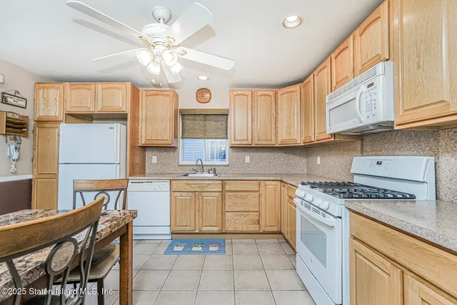 a kitchen with a white cabinets and window