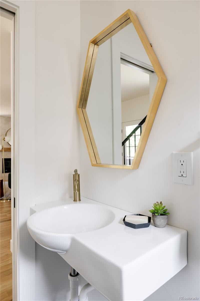 832 Adams Street Denver, CO 80206 - Photo 12 of 39 a bathroom with a sink and a mirror