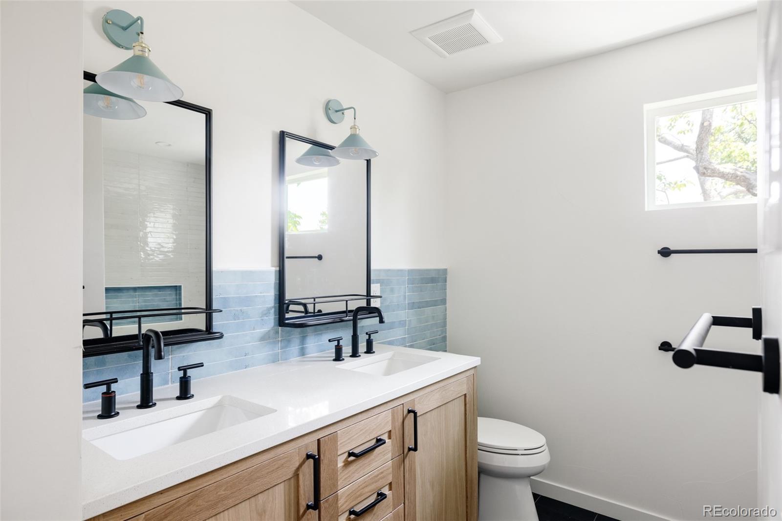832 Adams Street Denver, CO 80206 - Photo 27 of 39 a bathroom with a toilet sink and mirror