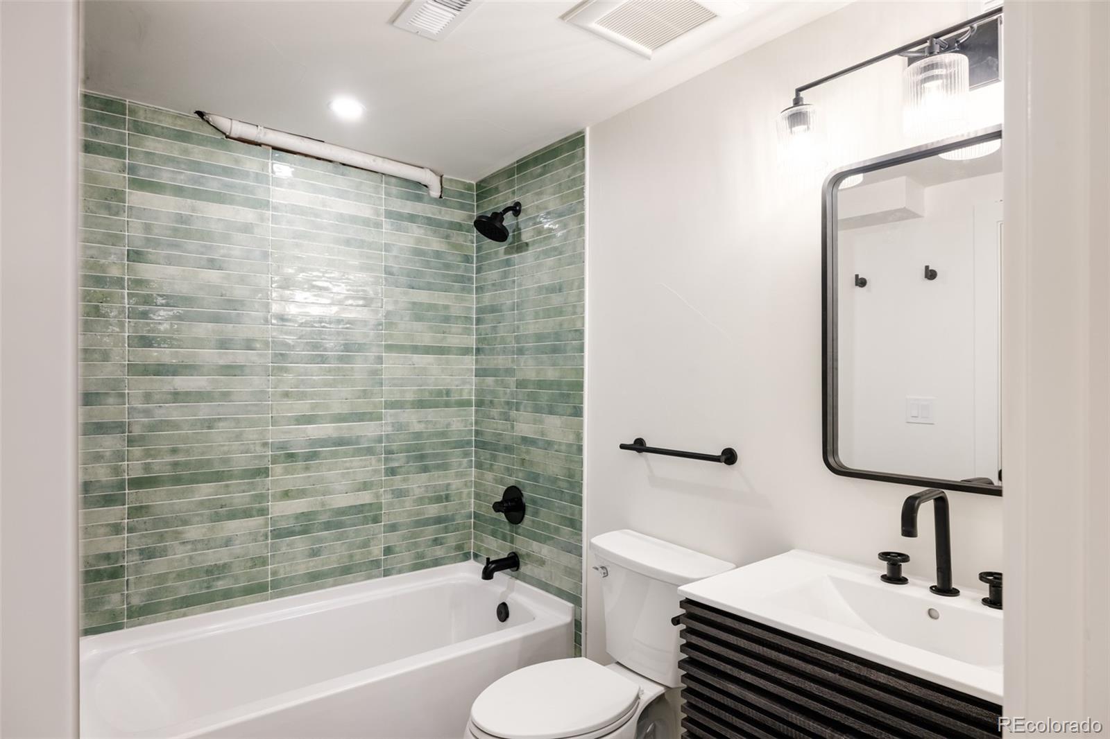 832 Adams Street Denver, CO 80206 - Photo 32 of 39 a bathroom with a sink toilet and shower