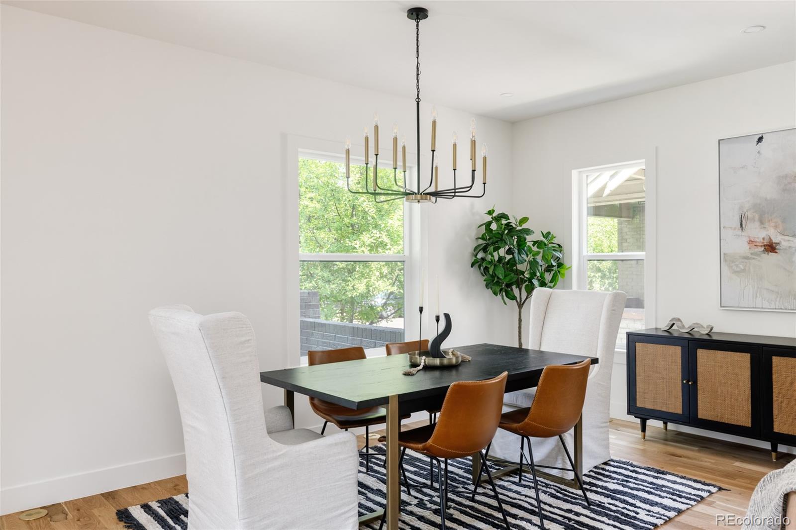 832 Adams Street Denver, CO 80206 - Photo 6 of 39 a view of a dining room with furniture window and wooden floor