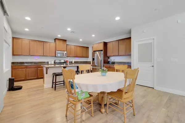 a kitchen with stainless steel appliances granite countertop a stove a sink a microwave and a refrigerator