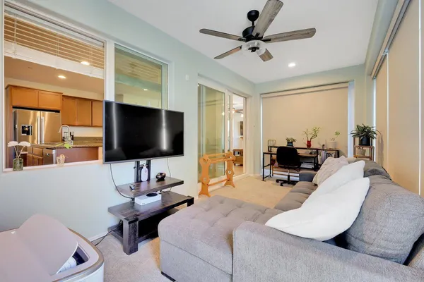a living room with furniture and large windows