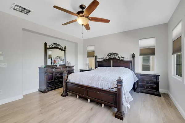 a bedroom with a bed and a large window